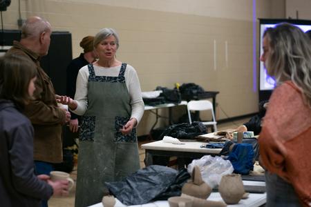 Students and faculty chat with artist Jan McKeachie Johnston during a ceramics workshop. - Photo by Faith Orr