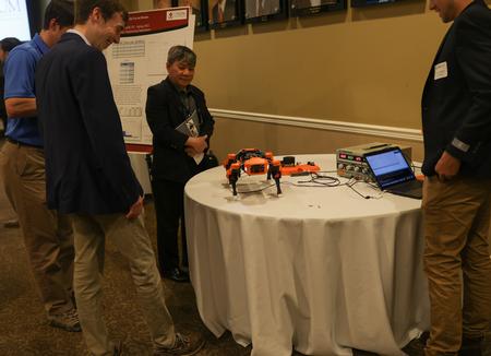 Senior engineering majors, Nathan Golden and Noah Simpson, share their poster project entitled "Exploring LiDAR navigation for Use in Quadruped Robots" with Dr. Don Van at the Scholarship Symposium. - Photo by Suzanne Rhodes