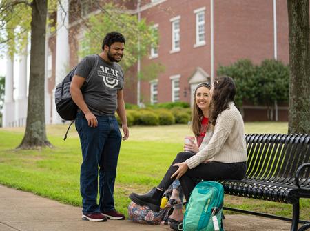 Jeremiah Chapman, Rachel Graves, and Maria Wentley chat outside White Hall. - Photo by Kristi McMurry Woody