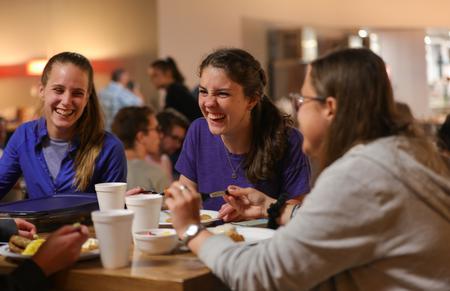 Tori Graves, Lydia Cyrus, and Natalie Nagy laugh together during the annual Food for Finals event. - Photo by Suzanne Rhodes