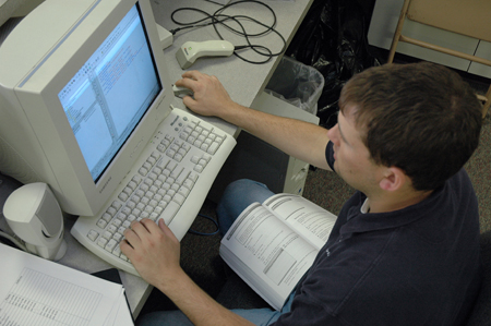Senior Wayne Campbell makes some code changes in preperations for his senior seminar computer science presentation for the second annual scholarship symposium. - Photo by Amanda Herron