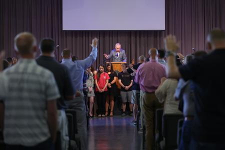 President Oliver leads prayer with families of graduating seniors during the annual commissioning service. - Photo by Suzanne Rhodes