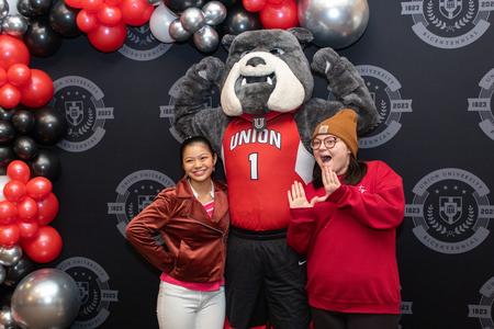 Students Olivia Netland and Chloe Perkins pose with Buster the Bulldog during Union's 200th birthday party. - Photo by Lyla Dietz