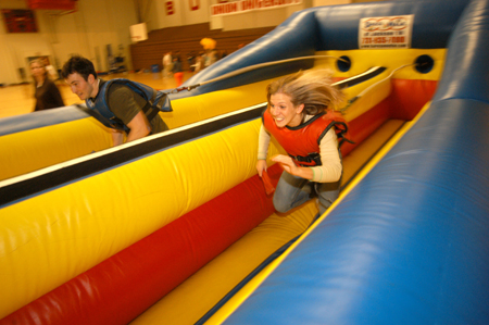 Two incoming freshman race one another at one of the inflatable games during Spring Thing. - Photo by Morris Abernathy