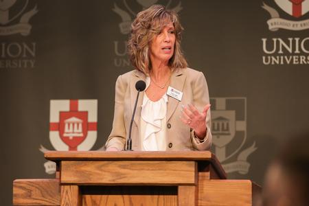 4/27/23 - Karen Miller, interim dean for the McAfee School of Business, introduces Frank Harrison, CEO of Coca-Cola Consolidated, for the annual Faith in the Marketplace luncheon. - Suzanne Rhodes