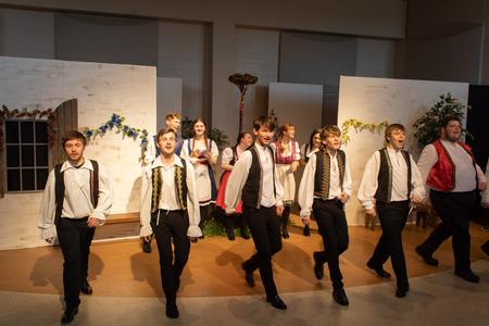 The student cast performs in the Opera Workshop's production of "The Bartered Bride." Front row: Sebastian Woods, Isaac Reid, Micah Lilyquist, Landon Stoub, Andrew Richardson, and Alex Henry. Back row: Jamin Sinclair-Lee, Katie Ryder, Averee Dunivan, Maren Taylor, and LeAnne Dudley - Photo by Abigail Aspinwall