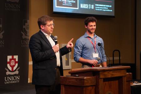 Dean Ray Van Neste introduces Theology & Missions major Arden Pearce during the annual Ryan Center Bible Conference. - Photo by Lauren Steed