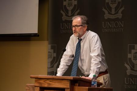 Bobby Rogers, professor of English and writer in residence, introduces Graham Hillard for a creative writing workshop reading.  - Photo by Abigail Aspinwall