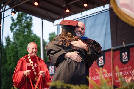 5/6/23 - George Moss, professor of mathematics, hugs his daughter Anna after she was awarded the the 113th Tigrett Medal at Spring Graduation. - Kristi McMurry Woody