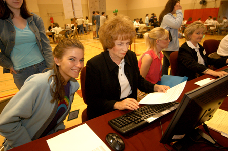 Provost administrative assistant Linda Baker helps an eager incoming freshman register for classes. - Photo by Morris Abernathy