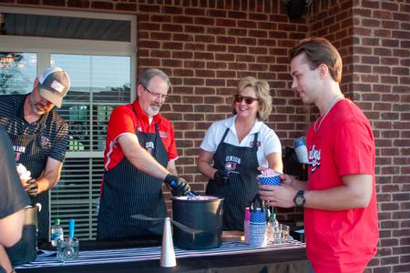 8/19/23 - Executive Council members Bryan Carrier, John Netland, and Catherine Kwasigroh serve ice cream at President Oliver's house during Welcome Week. - Lauren Steed