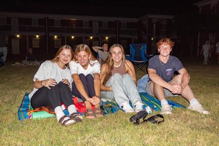 Families enjoy a movie during SAC's Movie on the Lawn during Family Weekend. - Photo by Lyla Dietz