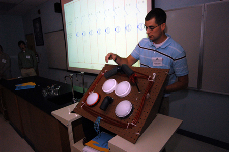 David Foster, a senior engineering major, discusses his engineering research project at the Scholarship Symposium. - Photo by Morris Abernathy