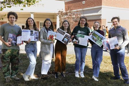 David Alcazar, Noel Moore, Faith Orr, Avery Chenault, Katherine Anne Thierfelder, Olivia Bell, and Samuel Stettheimer pose with their work on Cardinal & Cream Magazine Release Day during Homecoming Week. - Photo by Karley Hathcock