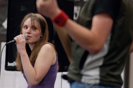 Bess Perrier, lead singer of Bellwether, watches bassist Matthew Diggs perform a solo during their set at the Battle of the Bands event hosted by the Freshman Council to support Relay for Life. - Photo by Kristen Nicole Sayres