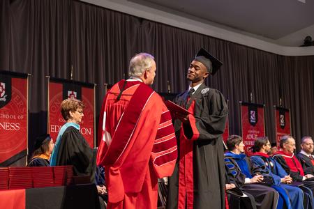 12/14/24 - Kobi Mosely, commercial music major, receives his bachelor's degree from President Oliver. - Karley Hathcock