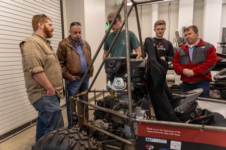Students, alumni, donors, and guests check out the Baja project in the Shop during The Ethos Forum dedication. - Photo by Jim Gandy