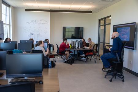 Brian Glas, chair of the Department of Computer Science, teaches in a new computer lab in The Ethos Forum shortly after its dedication. - Photo by Karley Hathcock