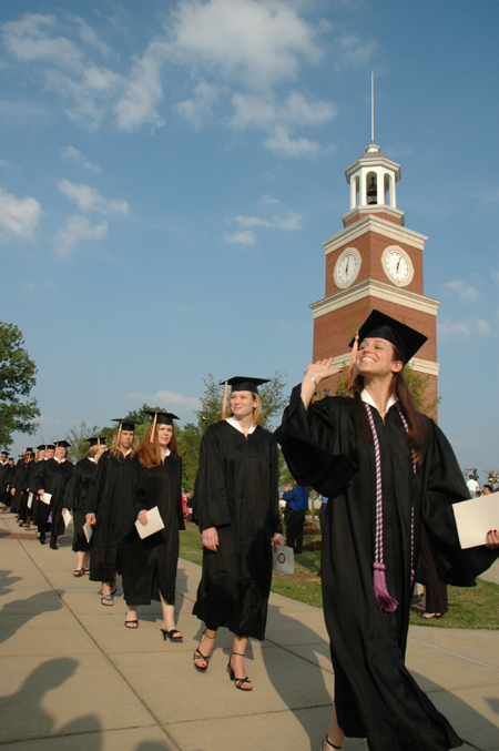 Graduates file onto the Great Lawn for the spring graduation ceremony. - Photo by Jim Veneman
