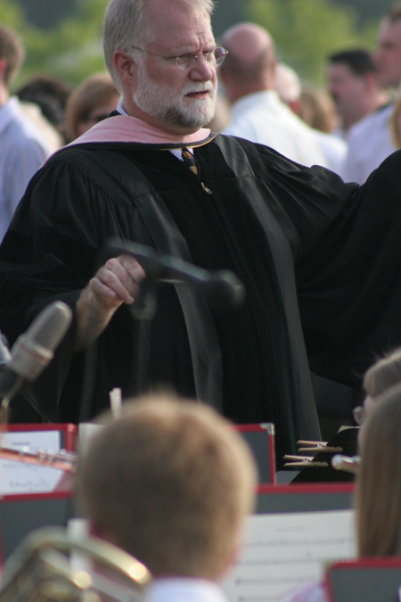 David McClune leads the Symphonic Band in <i>Pomp and Circumstance</i> as the 415 graduates make their way to their seats at spring graduation. - Photo by Kyle Kurlick