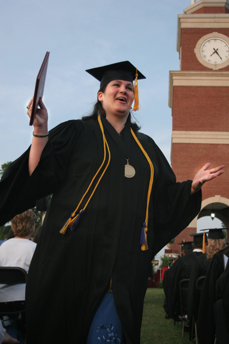 Pychology and sociology graduate Alisha Reeves celebrates after receiving her degree at spring graduation.  Alisha is the first member of her family to graduate from college.  - Photo by Kyle Kurlick