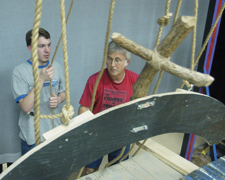 Sophomore Jeremy Parker, theater major, and David Burke, associate professor of communication arts, raise the complex set of “Lilies of the Field” using a system of pulleys and rope. - Photo by Justin Veneman