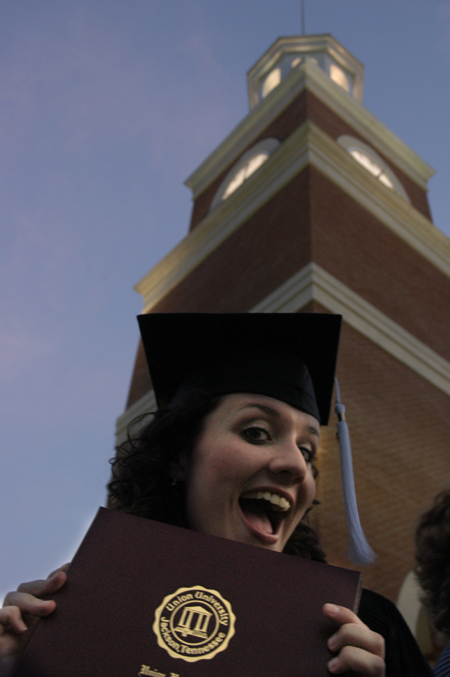Broacasting graduate Ashley Mitchell shows off her diploma shortly after the spring graduation ceremony. - Photo by Kathleen Murray