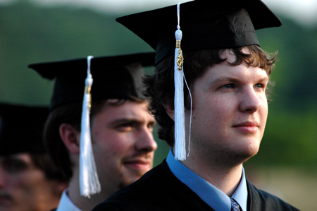 Public relations graduate Ross Kyzar (foreground) and music graduate Chris Lyles (background) look toward the future during spring graduation. - Photo by Kristen Nicole Sayres