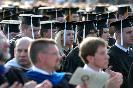 Graduates focus on the words of wisdom directed at them during spring graduation. - Photo by Morris Abernathy