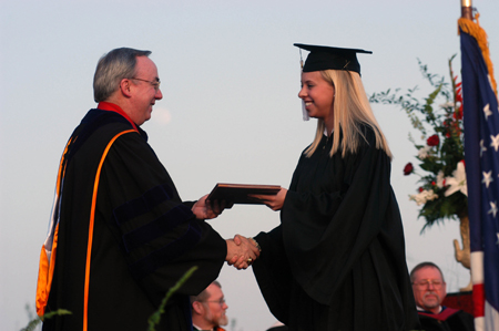 President Dockery presents public relations graduate Jill Martin with her diploma during spring graduation. - Photo by Morris Abernathy