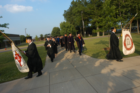 The graduate and faculty processional lines diverge to file onto the Great Lawn. - Photo by Morris Abernathy