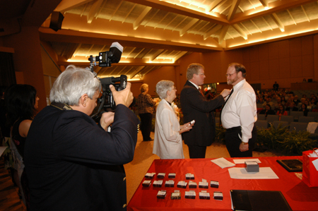 Dean Tim Smith pins graduate Greg Mayfield during the nursing dedication service. - Photo by Morris Abernathy