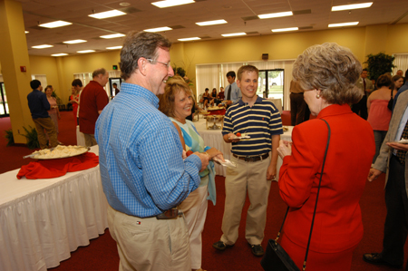 Graduating senior Ryan Martin fellowships with his family and Business professor Debbie Newell during the Graduates' Reception. - Photo by Morris Abernathy