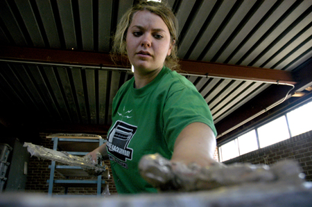 Sophomore April Wright assists during the sculpture workshop with artists Berry Matthews and Ron Fondaw. - Photo by Kathleen Murray
