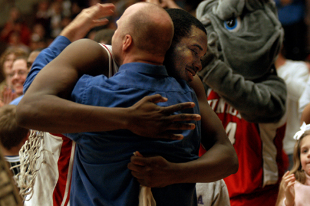 Union head coach Ralph Turner and sophomore center Pierry Valmera exchange a hug after Union's win in the TranSouth Conference Tournament championship game. - Photo by Jonathan Blair