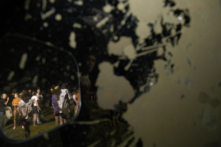 Junior Kelly Reid throws mud at the photographer while she hides out in a truck during Midnight Mudness. - Photo by Kathleen Murray