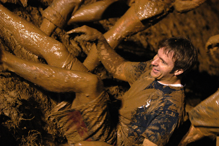 Junior Chad Glenn, biology major, reaches for help
after a tug-a-war game April 14. This annual event, sponsored by Young Alums, brings juniors together for a night of mud, games and fellowship with peers they would not normally interact with. - Photo by Kathleen Murray