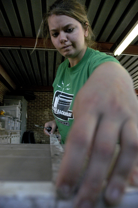 Sophomore April Wright assists during the sculpture workshop with artists Berry Matthews and Ron Fondaw. - Photo by Kathleen Murray