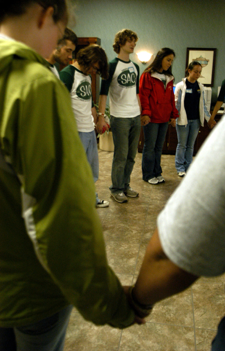 Members of SAC circle together for prayer prior to the Spring Thing 2005 concert with Scratch Track and Sanctus Real. - Photo by Kristen Nicole Sayres