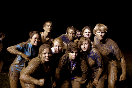 The winning team from Midnight Mudness 2005 flexes their mud muscles. Pictured from left to right: Kari Mynatt, Jennifer Winfield, Tony Winkler, Emily Kuhnert, Whitney Culver, Lindsay Grace Brown, Brittany Stephens,Bethany Little, Jennifer Hanes and Nathan Michael. - Photo by Kathleen Murray