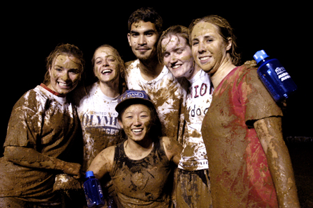 A Midnight Mudness team shows off their mud.  Pictured from left to right: Michelle Pierce, Lendy Wilson, Eunice Sung (front), Chris Clermont, Laura Hicks and Christina Schulz. - Photo by Kathleen Murray