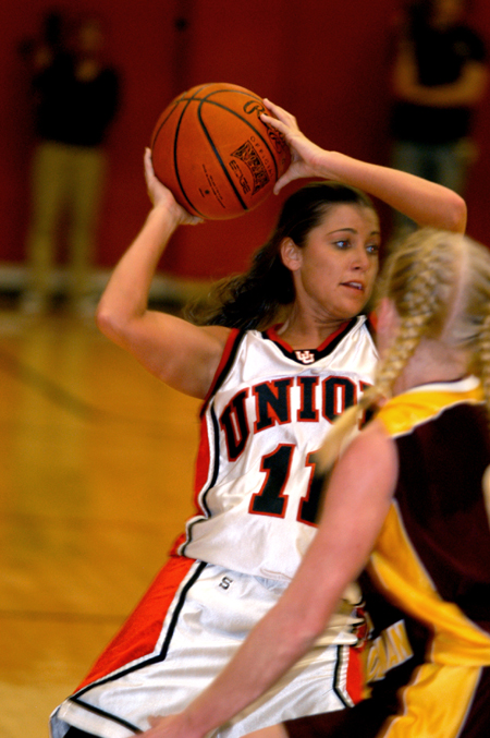 Jennifer Henson looks to pass to an open teammate as she is defended by a Freed-Hardeman player. - Photo by Jonathan Blair
