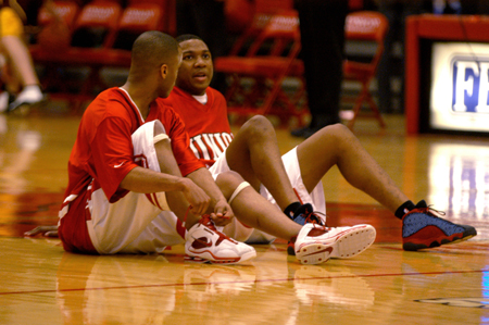 Rod Ross and Chris Williams have a talk as they sit at half court before their game.
 - Photo by Jonathan Blair