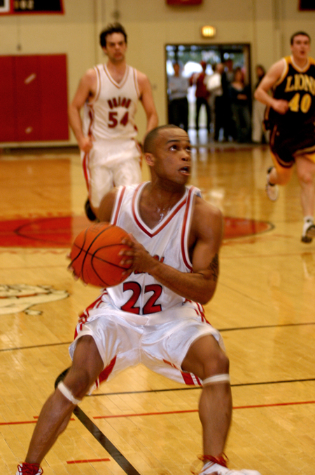 Rod Ross goes up for a shot as teammate Ben Frederick follows down the court.
 - Photo by Jonathan Blair
