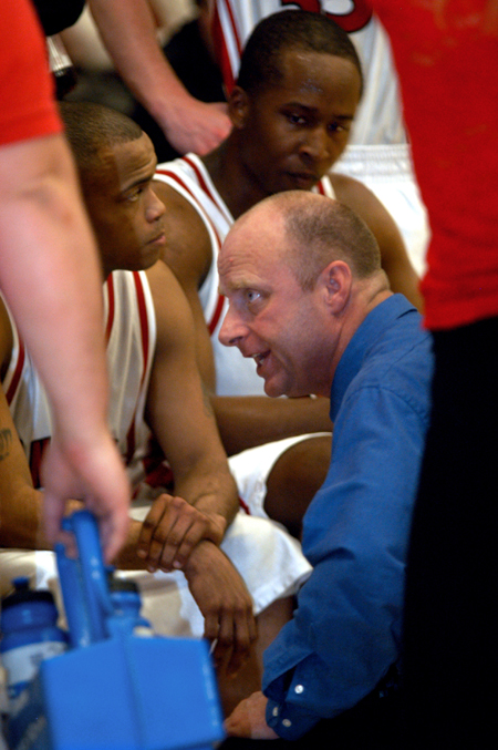 Coach Turner gives instructions to his team as the Bulldog players look on. - Photo by Jonathan Blair