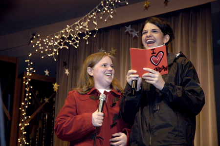 Seniors Becky Johnson and Jodie Curtis read a card about fellow Union student Landon Preston while hosting the Variety Show. - Photo by Kathleen Murray