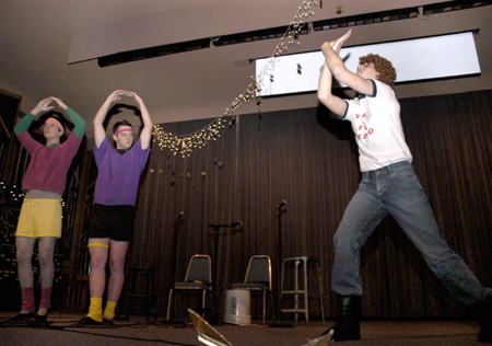 Happy Hands Club member, Napoleon Dynamite, played by Freshman Ross Barnes flys away with other Lambda Chi members Freshman Jonathan Abernathy and Sophomore Gareth Munro at the Variety Show. - Photo by Kathleen Murray