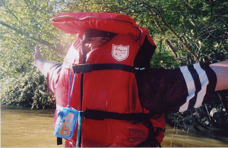 Senior Jonathan Blair peeks out of his life jacket after being pulled back into the boat during Adventure Programs' whitewater rafting trip. - Photo by Cam Tracy