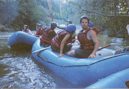 Eager students take a quick break while riding the Ocoee River during Adventure Programs' whitewater rafting trip. - Photo by Jonathan Blair