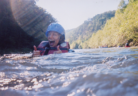 Residence Director Ema Wall enjoys a quick swim while floating the Ocoee River during Adventure Programs' white water rafting trip. - Photo by Jonathan Blair